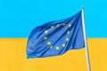 Ukraine and European Union. Waving European Union flag against blue yellow wall ukrainian flag. Ukraine goes to Europe concept