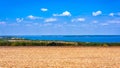 Ukraine.Fields on the shore of the reservoir.The harvest in the fields has been collected.Blue sky with white clouds. Royalty Free Stock Photo