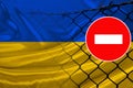 Ukraine flag on satin, fence with barbed wire, symbolic red sign no entry, entry prohibited, travel restrictions across European Royalty Free Stock Photo