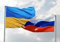 Ukraine Flag on Urss Russia Flag with clear sky in background Royalty Free Stock Photo