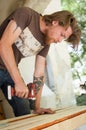 Ukraine, Goshcha, voluntary event, - August, 2021 - skilled young male worker is using power screwdriver drilling during Royalty Free Stock Photo