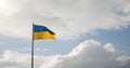 Ukraine independence patriotic concept of blue and yellow banner flagpole blowing on a wind with cloudy background scenic view