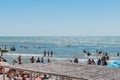 Ukraine, Iron Port - August 24, 2020: Resort area, sea shore and beach with tourists and vacationers against the blue sky and