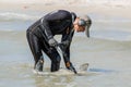 Ukraine, Iron Port - September 01, 2020: A man with a special device and equipment metal detector looking for lost jewelry and