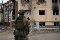 20.05.2022 Ukraine. Irpin. A Ukrainian soldier stands and looks at the bombed houses by the Russian army in Irpin.