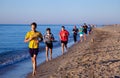 Ukraine, Karolino-Bugaz - August 18, 2020: Boys teenagers athletes run along the seashore. Sports on the beach. People