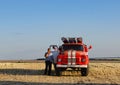 Ukraine, Kharkiv region, field, August 08, 2020 fire trucks on the field near pressed briquettes with advertising advertising Royalty Free Stock Photo