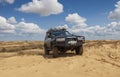 Ukraine, Kherson region, Oleshky Sands - June 2011: 4x4 jeep in the sand desert.