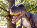 Ukraine, Khmelnitsky, October 2021. Dinosaur model in the park. Giant tyrannosaurus at an exhibition in the park on a summer sunny