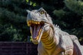 Ukraine, Khmelnitsky, October 2021. Dinosaur model in the park. The head of a albertosaurus with sharp teeth