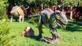 Ukraine, Khmelnitsky, October 2021. Dinosaurs model in the park. Giant megaraptor and triceratops at an exhibition in the park on