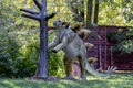 Ukraine, Khmelnitsky, October 2021. A model of a dinosaur, stegosaurus standing on its hind legs near a tree