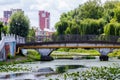 Ukraine, Khmelnytsky, July 2020. City park with a river and a bridge in summer