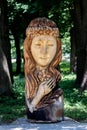 Ukraine, Khmelnytsky. July 2020. Wooden sculpture of a woman of Slavic appearance in a city park