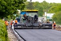 Ukraine, Khmelnytsky region, Krasyliv. May 2021. Asphalt paver on the road during asphalt laying. Road repair. Laying a new road