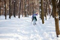 Ukraine, Kiev, City Forest in March, 2018. Active rest of retiree woman.Active middle aged woman skiing through winter forest