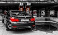 Ukraine, Kiev - March 27, 2020: classic tuning of a black German BMW car in an underground parking lot. Black and white photo,