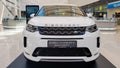 Ukraine, Kiev - March 27, 2020: Land Rover Discovery Sport shiny modern white car at the exhibition. Body, headlights close-up, Royalty Free Stock Photo