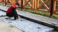 Ukraine, Kiev - May 12, 2020: laying of gray paving slabs on the city square, repair of the sidewalk. Professional masons install Royalty Free Stock Photo