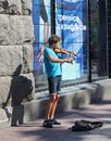 UKRAINE, KIEV - May 27,2013: Young violinist playing on the street Khreschatyk for passers