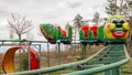 Ukraine, Kiev - October 24, 2019: roller coaster type attraction. Caterpillar-shaped roller coaster train in an amusement park.
