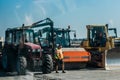 Ukraine, Kiev region - September 02, 2020: Tractor, asphalt paver and bulldozer industrial equipment for asphalt laying and road Royalty Free Stock Photo