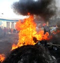 Ukraine. Kiev. Revolutionaries in helmets and masks near flaming tires. Royalty Free Stock Photo