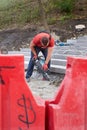 Ukraine, Kiev - September 12, 2019: A worker uses a hammer drill for construction work in a park