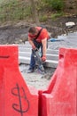 Ukraine, Kiev - September 12, 2019: A worker uses a hammer drill for construction work in a park Royalty Free Stock Photo