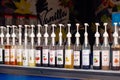 Various sweet syrups in plastic bottles with dispensers at an ice cream kiosk on the market.