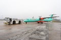 Ukraine, Kyiv - December 29, 2020: The passenger plane is towed for takeoff on a rigid coupling. Foggy airport, bad visibility and