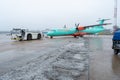 Ukraine, Kyiv - December 29, 2020: The passenger plane is towed for takeoff on a rigid coupling. Foggy airport, bad visibility and