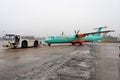 Ukraine, Kyiv - December 29, 2020: The passenger plane is towed for takeoff on a rigid coupling. Foggy airport, bad visibility and