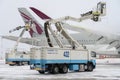 Ukraine, Kyiv - February 12, 2021: De-icing the aircraft before the flight. The deicing machine. Passenger plane with antifreeze.