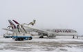 Ukraine, Kyiv - February 12, 2021: De-icing the aircraft before the flight. The deicing machine. Passenger plane with