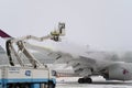 Ukraine, Kyiv - February 12, 2021: De-icing the aircraft before the flight. The deicing machine. Passenger plane with