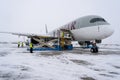 Ukraine, Kyiv - February 12, 2021: Loading luggage into the luggage compartment of the aircraft. Winter airport. A Qatar