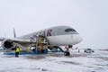 Ukraine, Kyiv - February 12, 2021: Loading luggage into the luggage compartment of the aircraft. Winter airport. A Qatar Airlines