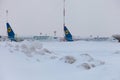 Ukraine, Kyiv - February 12, 2021: Planes at Winter. Aircraft. There is a lot of snow at the airport. Bad weather and visibility. Royalty Free Stock Photo