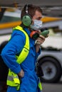 Ukraine, Kyiv - July 14, 2020: The dispatcher speaks on the radio. Male worker in a medical mask. Service engineer at the airport