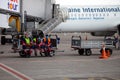 Ukraine, Kyiv - July 8, 2020: Masked people. The man works during quarantine. Airport outdoor. Workers in medical masks without