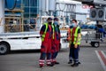 Ukraine, Kyiv - July 8, 2020: Masked people. The man works during quarantine. Airport outdoor. Workers in medical masks without