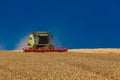 Ukraine. Kyiv. JULY 23, 2022: Modern combine Claas Lexion harvesting grain in the field.Combine harvest on grain field.