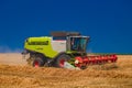 Ukraine. Kyiv. JULY 23, 2022: Modern combine Claas Lexion harvesting grain in the field.Combine harvest on grain field.