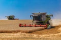 Ukraine. Kyiv. JULY 23, 2022: Modern combine Claas Lexion harvesting grain in the field.Combine harvest on grain field.