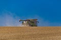 Ukraine. Kyiv. JULY 23, 2022: Modern combine Claas Lexion harvesting grain in the field.Combine harvest on grain field.