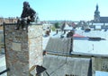 Ukraine, Lviv, sculpture a chimney sweep on the roof of the House of Legends