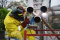 Welding works on welding of metal structures. An electric welder works on scaffolding. Royalty Free Stock Photo