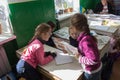Girls with a book in their hands at the lesson,3.11. 2014 Ukraine Mervichi, The girl shows a textbook to her classmates