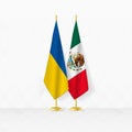 Ukraine and Mexico flags on flag stand, illustration for diplomacy and other meeting between Ukraine and Mexico